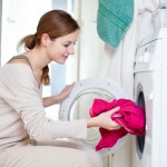 Housework: young woman doing laundry